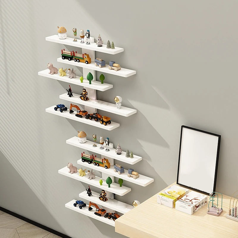 White wall shelves with decorative items against a gray wall