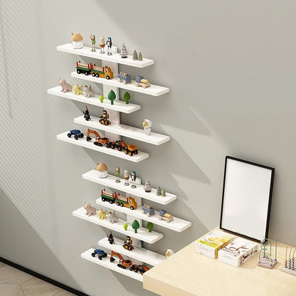 White wall shelves with decorative items against a gray wall
